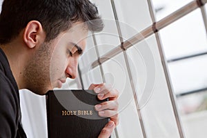 Man Praying by Window