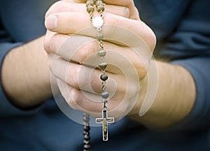 Man prays with a rosary photo