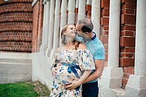 Man and pregnant woman, in an amorous couple in the park