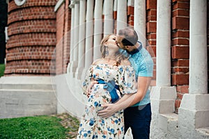 Man and pregnant woman, in an amorous couple in the park