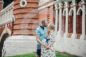 Man and pregnant woman, in an amorous couple in the park