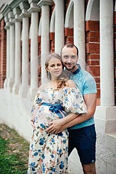 Man and pregnant woman, in an amorous couple in the park