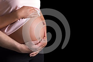 Man and pregnant woman caressing her belly