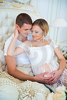 Man and pregnant woman happy together in anticipation of a child