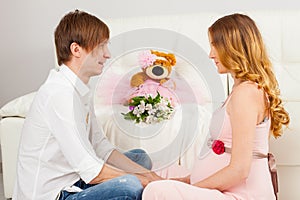 Man and pregnant woman sitting face to face