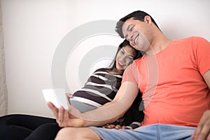 Man and pregnant woman watching son`s ultrasound