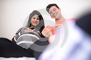 Man and pregnant woman watching son`s ultrasound
