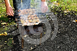 Man prepare meat on fire