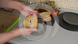 A man prepare a typical dish of Puglia friselle: taking one moisten frisa