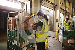 Man prepares and scans packages in a warehouse for delivery