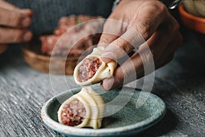 man prepares some Catalan stuffed galets