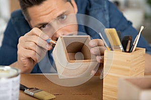 man prepares wood for painting or refinishing