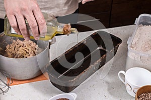 Man preparing bread dough on wooden table