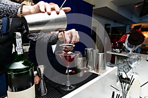 Man preparing cocktail in a glass