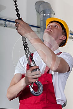 Man preparing crane hook to lifting materials