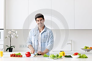 Man preparing delicious and healthy food in the home kitchen