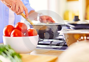 Man preparing delicious and healthy food in the home kitchen