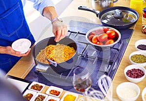 Man preparing delicious and healthy food in the home kitchen