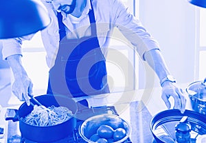 Man preparing delicious and healthy food in the home kitchen