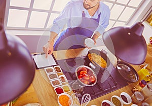 Man preparing delicious and healthy food in the home kitchen