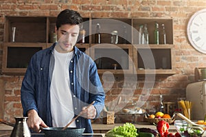 Man preparing delicious and healthy food in the home kitchen