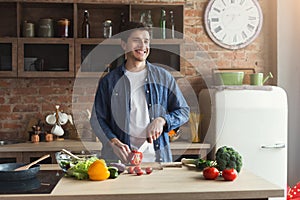 Man preparing delicious and healthy food in the home kitchen