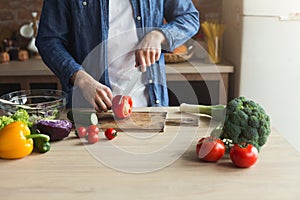 Man preparing delicious and healthy food in the home kitchen