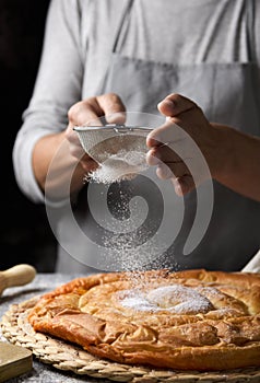 Man preparing ensaimada typical of Mallorca, Spain photo