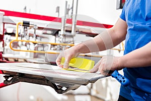 Man preparing fabric for screen printing.