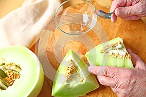 Man preparing honeydew melon