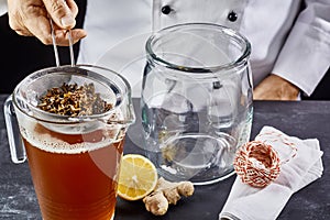 Man preparing kombucha tea in jar