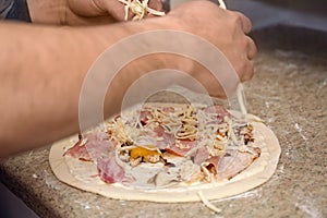 Man preparing pizza at table. Oven recipe