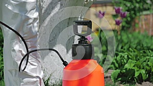 Man preparing pump sprayer for work in the garden