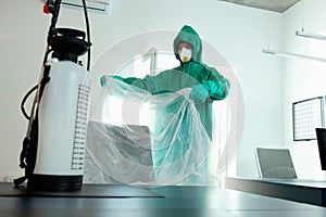 Man preparing the room for sanitation with chemicals stock photo