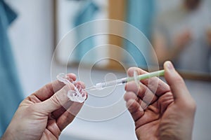 Man preparing silicon tray for teeth whitening