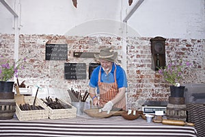 Man Preparing Speciality Sausages In Shop