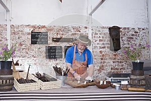 Man Preparing Speciality Sausages In Store