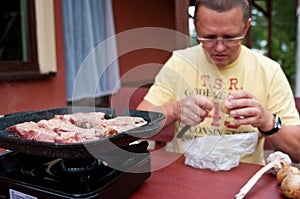 Man preparing tabletop grill