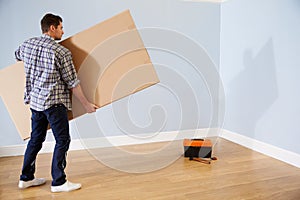Man Preparing To Assemble Flat Pack Furniture photo