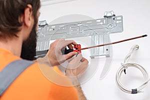 Man preparing to install new air conditioner. Modern air conditioner during the installation process