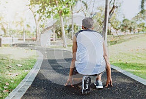 Man preparing to run in park