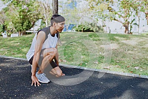 Man preparing to run in park