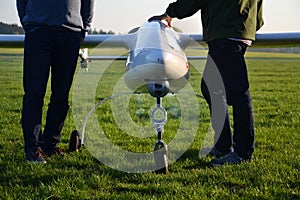 Man preparing unmanned aerial vehicle drone with light and camera