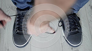 Man Preparing for a Walk Tying the Laces to His Sports Shoes