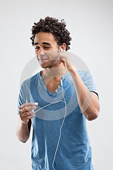 Man prepping earbuds with a smile