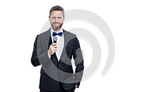 man presenter wear tuxedo in studio with copy space. presenter man speaking in microphone.