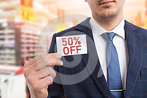 Man presenting card with fifty per-cent off concept
