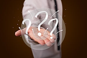 Man presenting hand drawn question marks