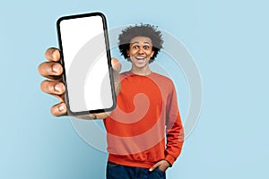 Man presenting a smartphone screen on blue background