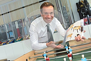 Man presenting table football game